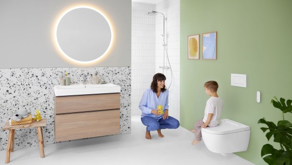 Femeie și copil într-o baie colorată cu oglinda Geberit Option și Geberit AquaClean Alba Femeie și copil într-o baie colorată cu oglinda Geberit Option și Geberit AquaClean Alba