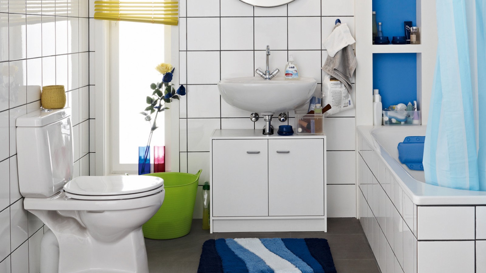 Baie aglomerată înainte de renovare, cu vas WC pe pardoseală şi rezervor vizibil Baie aglomerată înainte de renovare, cu vas WC pe pardoseală şi rezervor vizibil