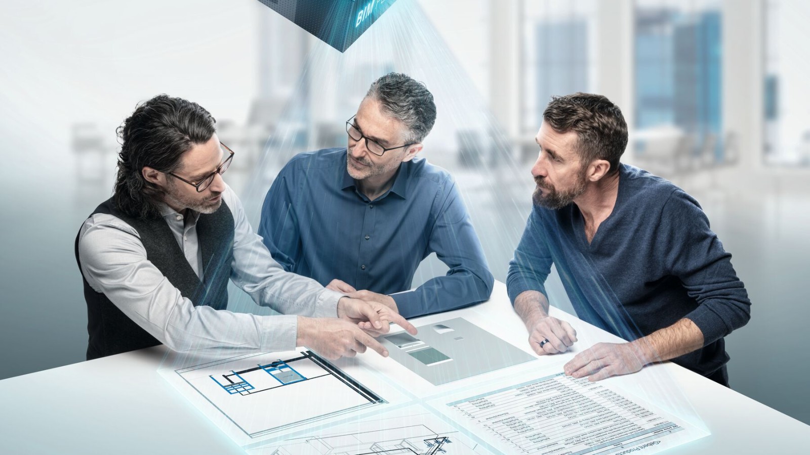 Proiectanţii în plină discuţie în jurul unei mese cu simbolul BIM
